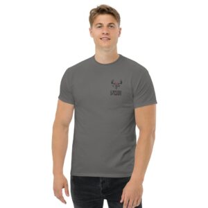 A man wearing a gray t-shirt with a deer on it is comfortably at home.