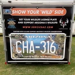 A home on wheels with a license plate that says show your wild side.